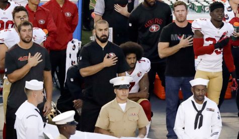 Photo of Colin Kaepernick kneeling during the national anthem 