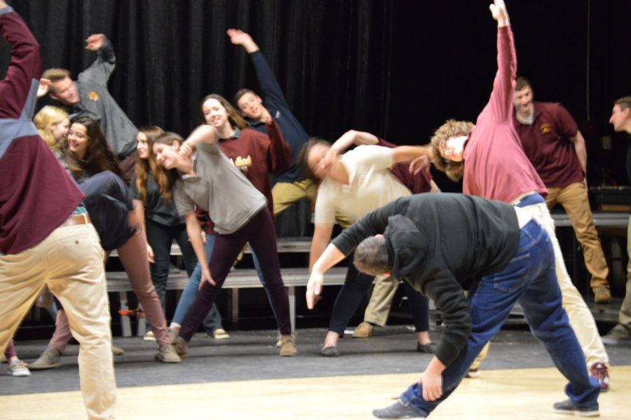 Rubber City Shakesphere Companys conductor of the workshop, Dane C.T. Leasure, shows students why it is important to stretch before acting. Not many students understand that acting can be physically demanding. 