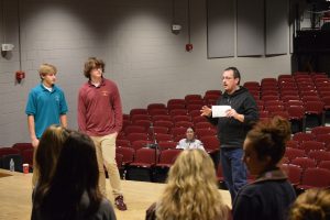 Dane Leasure is helping students learn their lines before they perform in front of their classmates. Students learn is that it is considered bad luck to say "Macbeth" while working on the play. 