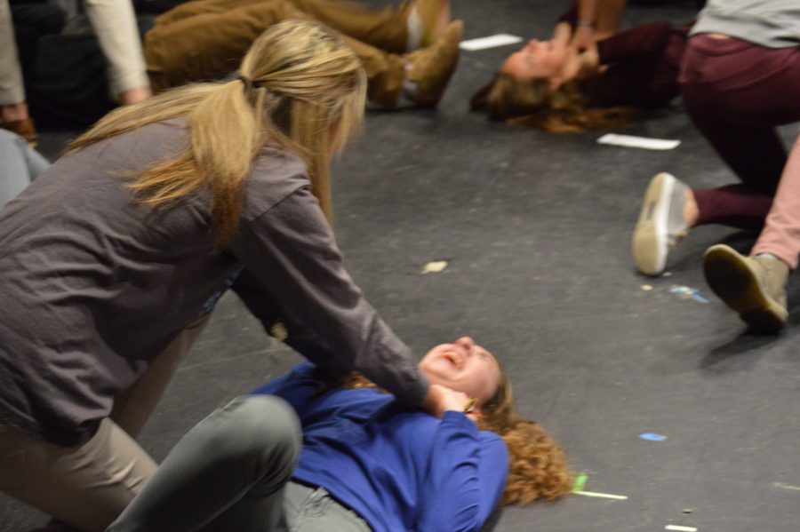 Junior Virgina Natale pins Jamie Cassamento. Virginia picked he role as the murderer, while Jamie was the son. Jamie has to play dead as she kicks her legs and yells for help. 