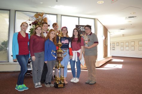 Members of WJs Harmony Gold Show Choir pose with the trophy they brought back to the school for taking fifth runner up. 