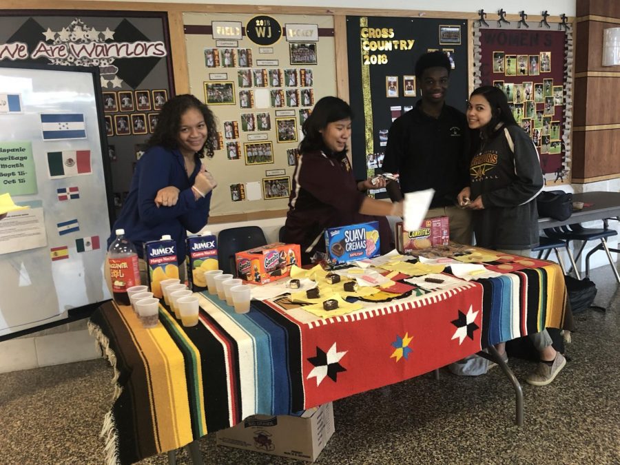 Seniors Kariya Spencer and Lorena Vicenteno work with freshmen Christian Tucker and Sarah Ortega at cultural taste testing event to celebrate Hispanic Heritage Month and diversity at WJ. 
