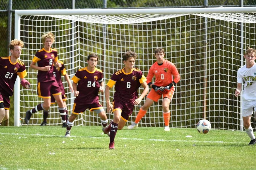 Junior Michael Robusto leads a break away with seniors Michael McShannic and Zach Marshall STVM. 