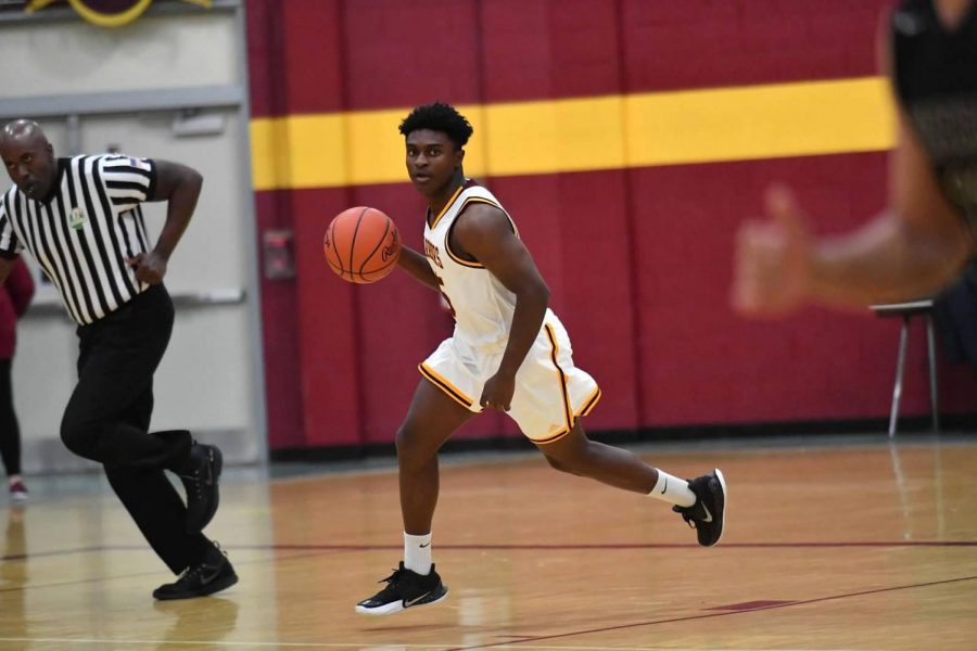 Senior Donovan Morris dribbles the ball past opponents at this home game. 