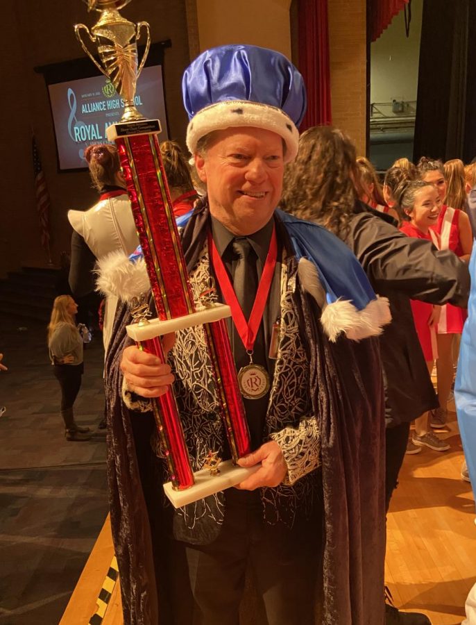 Mr. Banks, named king of the event, proudly holds the trophy won by Harmony Gold.