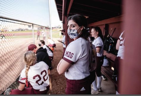 Miranda Herbele and teammates in the dugout in their game against St. Vincent/St. Mary  on April 26. 