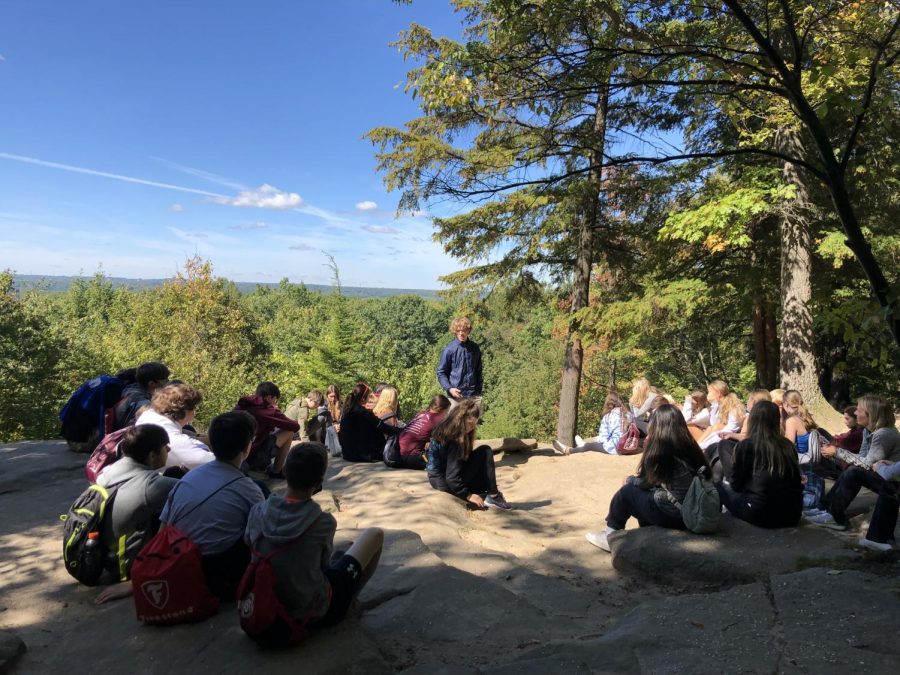 Senior+Tim+Burke+leads+a+reflection+at+the+CVNP+Ledges+Overlook+during+the+retreat.+