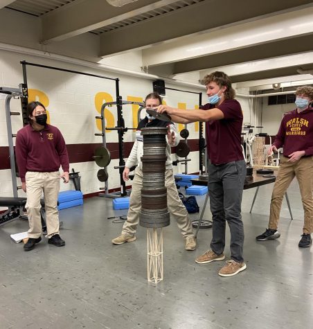 Junior Matthew Serdinak piles on the weight for his winning tower project. At 149 grams, his held the most weight overall. His beautifully crafted tower held an astonishing 385 pounds!