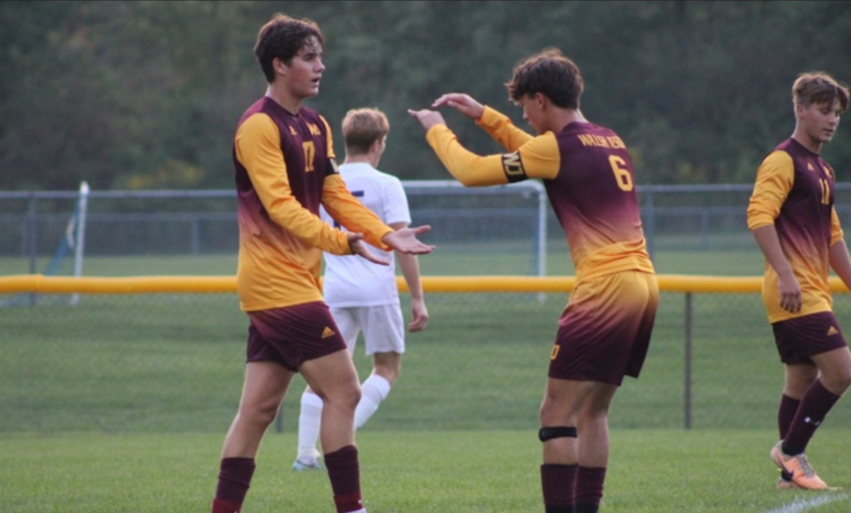 Captains (Sr. #6) Ryan Robusto and (Sr. #17) Charlie Robinson celebrate a goal against North Royalton High School. 
