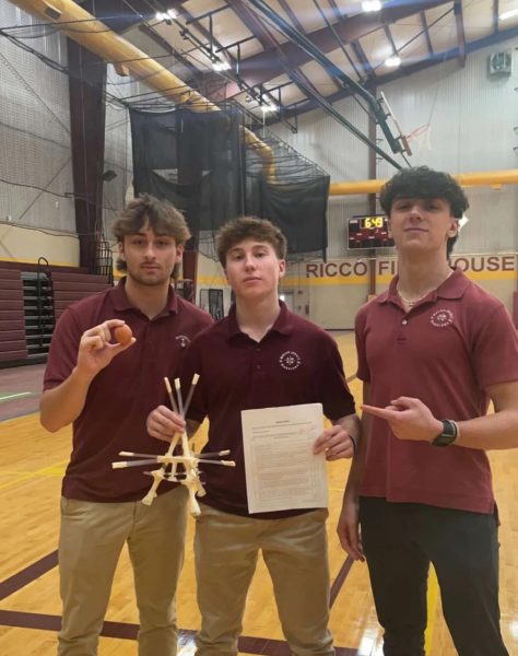 Competition winners Andrew Przybys (left), Steven Voinovich (middle), and Jake Brubaker (right) show off the egg contraption that earned them extra credit!