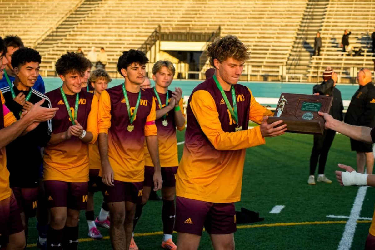 The team accepts the trophy after their victory over Stow in an OHSAA Division II boys match up in Parma on October 25. (Photo Akron Beacon Journal)