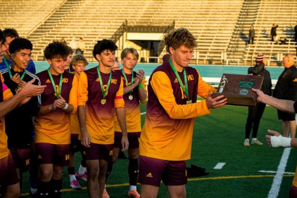 The team accepts the trophy after their victory over Stow in an OHSAA Division II boys match up in Parma on October 25. (Photo Akron Beacon Journal)